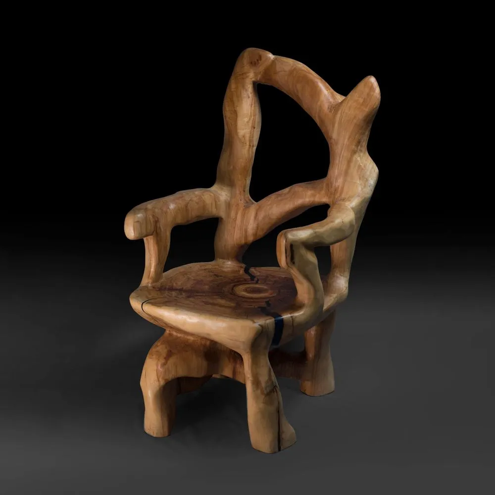 Veles, wooden armchair carved from single piece of wood